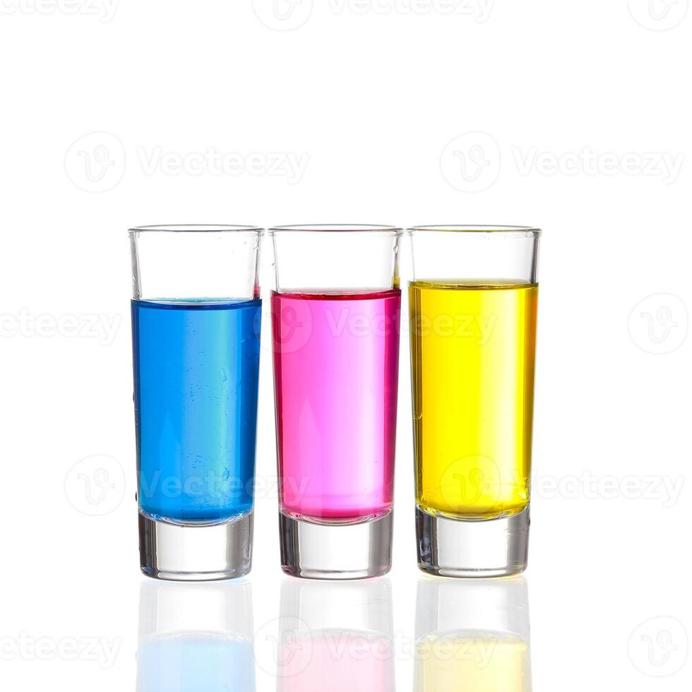 Shots - Three colourful shot drinks on a white background with reflections photo