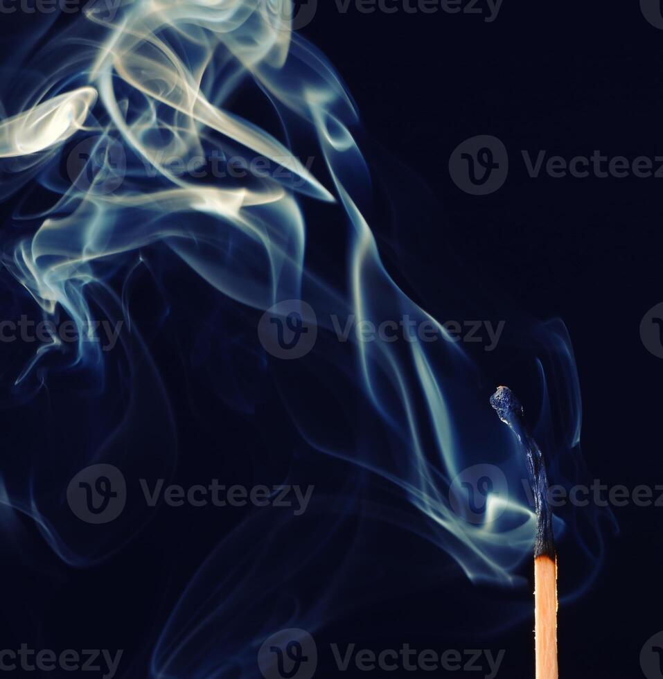 cyan smoke comes out from an extincted match photo
