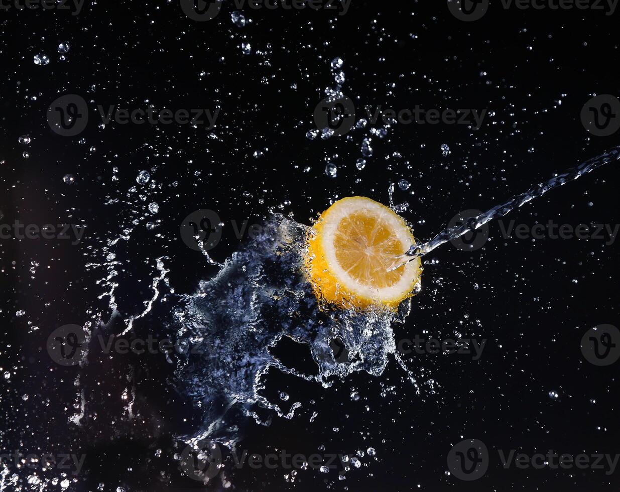 A high-speed shot of a lemon with splashing water, on a black background. photo