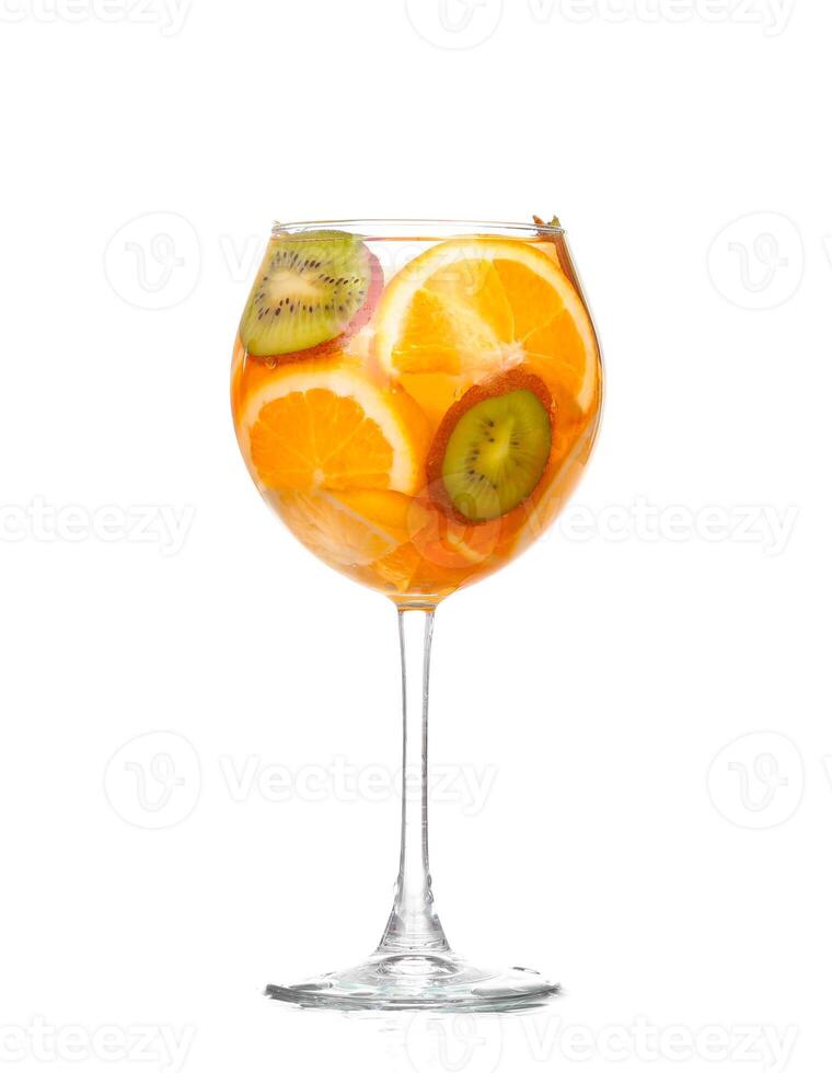 pitcher with a refreshing drink with lemon slices of orange and kiwi on white background photo