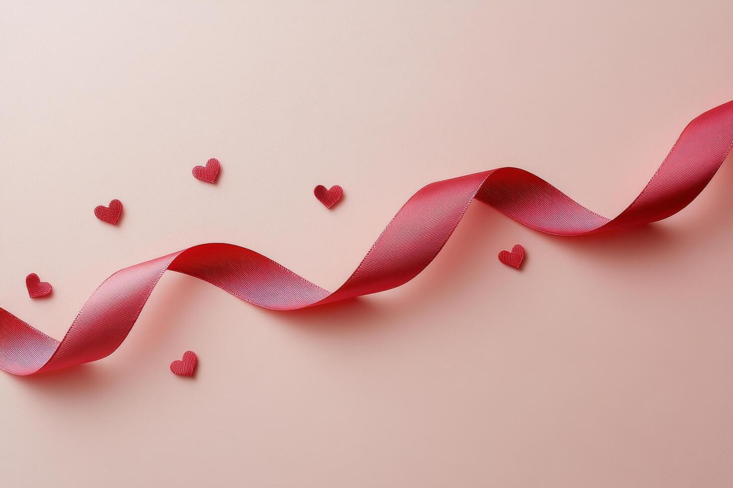 Decorative red ribbon with heart patterns on a soft pink background for festive occasions photo