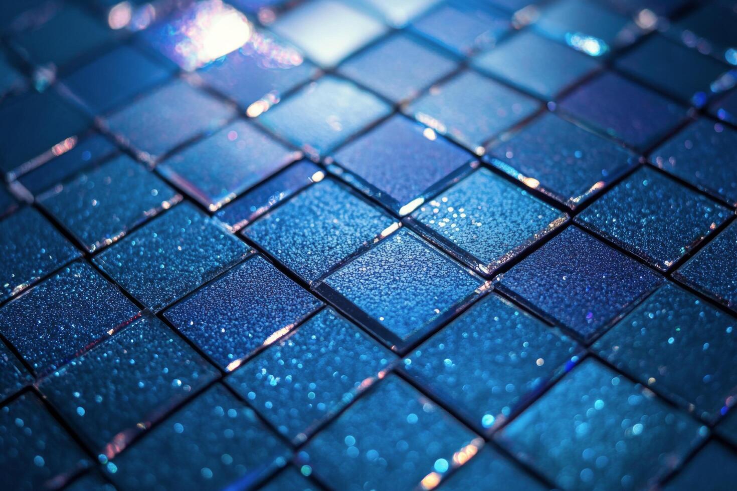 Close up view of shimmering blue tiles arranged in a square pattern on a wall photo