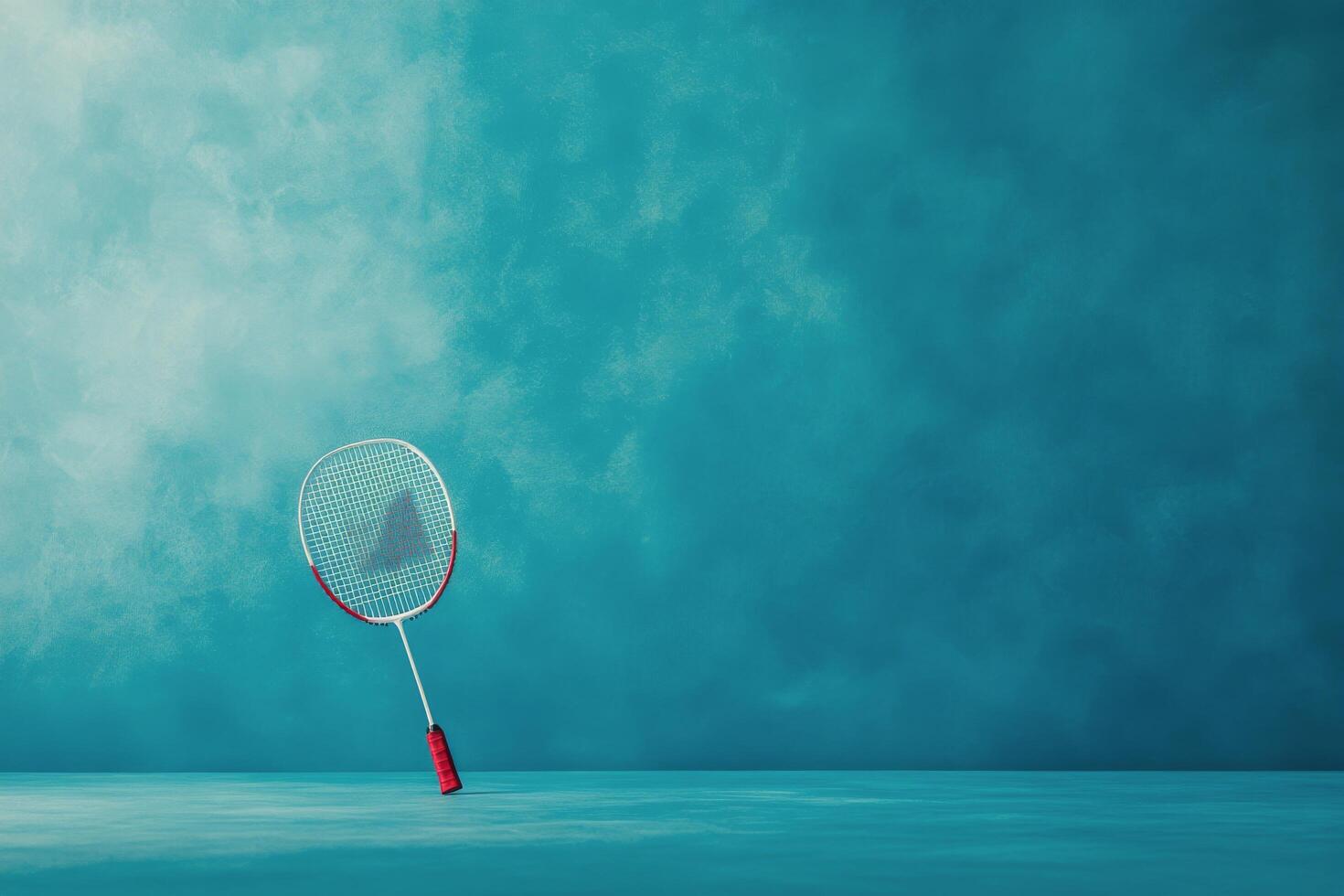 A tennis racket rests on the floor in a bright blue room with sunlight streaming through the windows photo