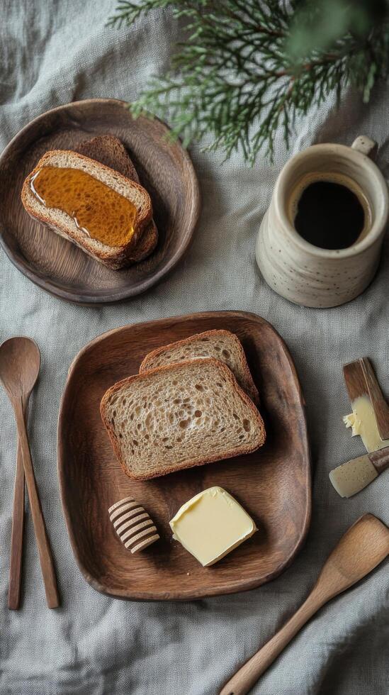 Breakfast setup with whole grain bread, butter, honey, and coffee on a linen tablecloth photo
