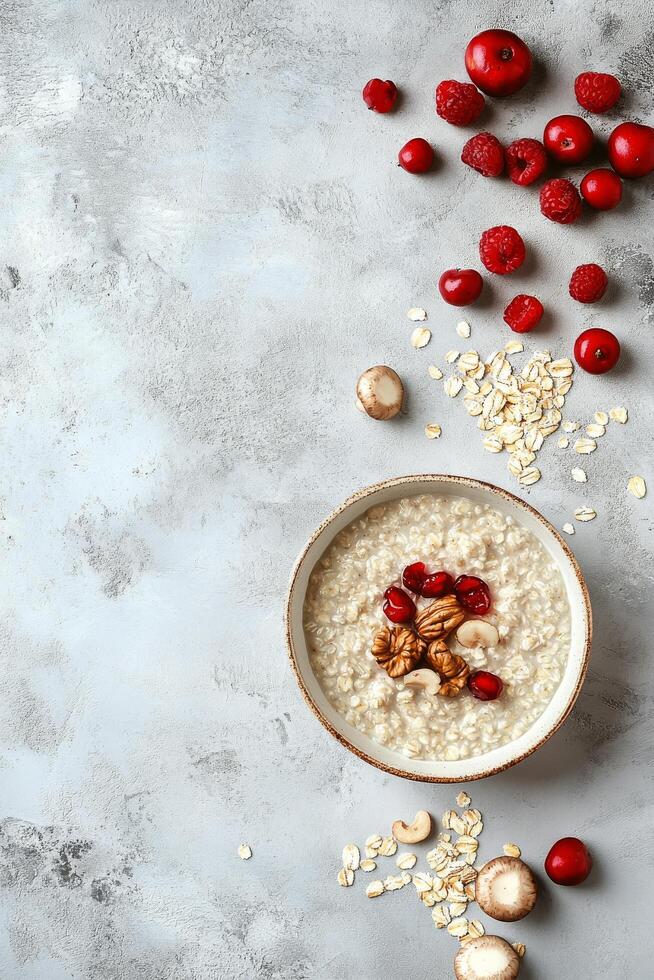 Breakfast bowl with oatmeal, berries, and nuts on a textured surface photo