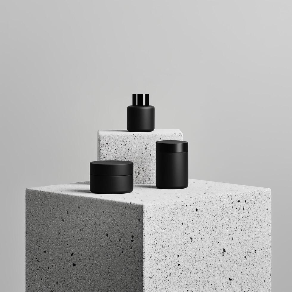 Minimalist cosmetic product mockup featuring sleek black containers displayed on textured concrete blocks against a neutral background. Perfect for showcasing high-end skincare, beauty, photo