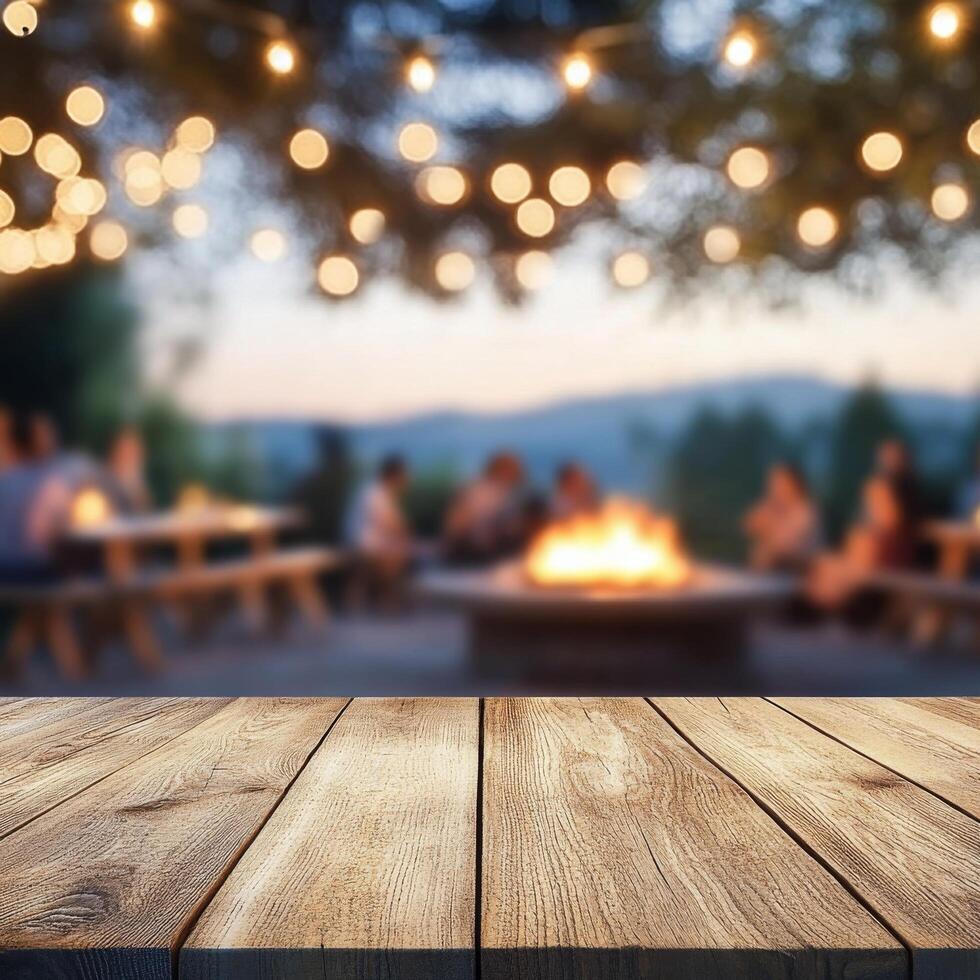 Evening gathering around a fire with string lights illuminating the outdoor setting at dusk photo