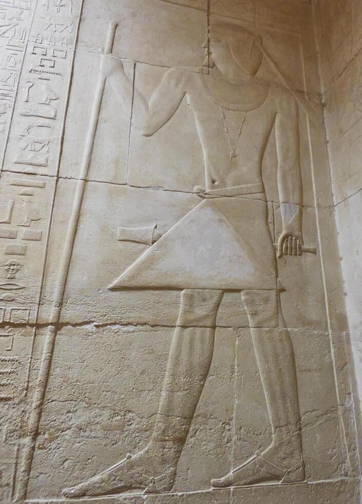old egypt hieroglyphs carved on the stone photo