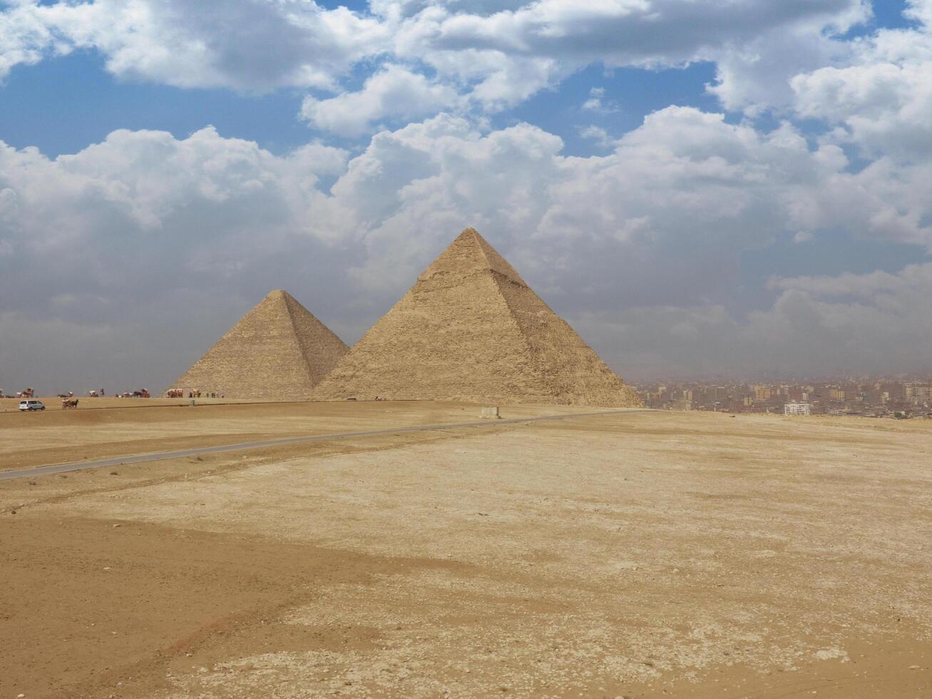 Egyptian pyramids in sand desert and clear sky photo