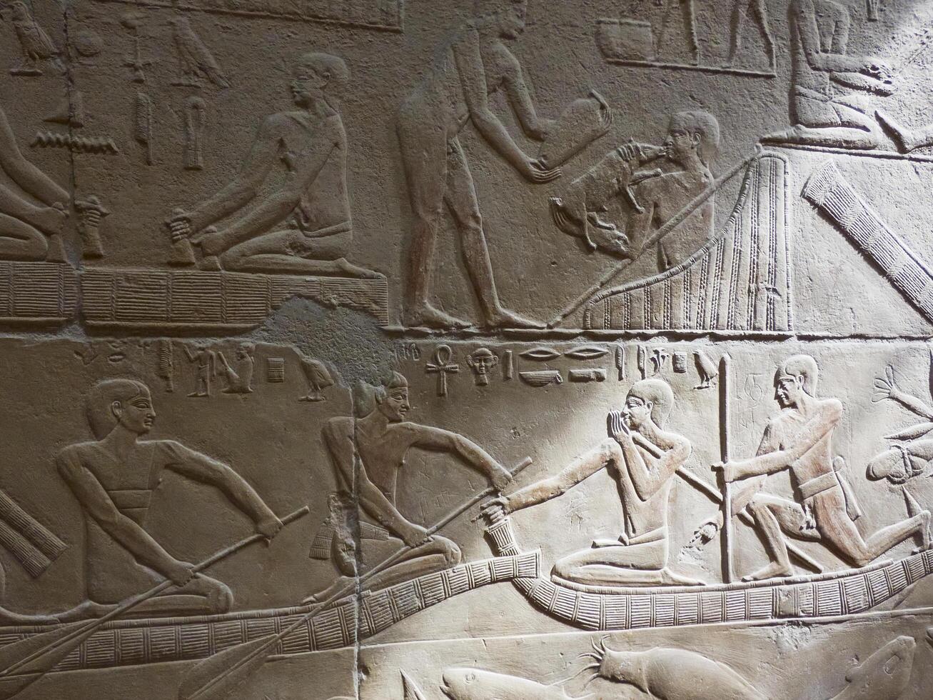 old egypt hieroglyphs carved on the stone photo