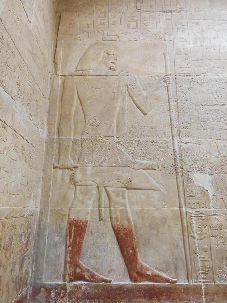 old egypt hieroglyphs carved on the stone photo