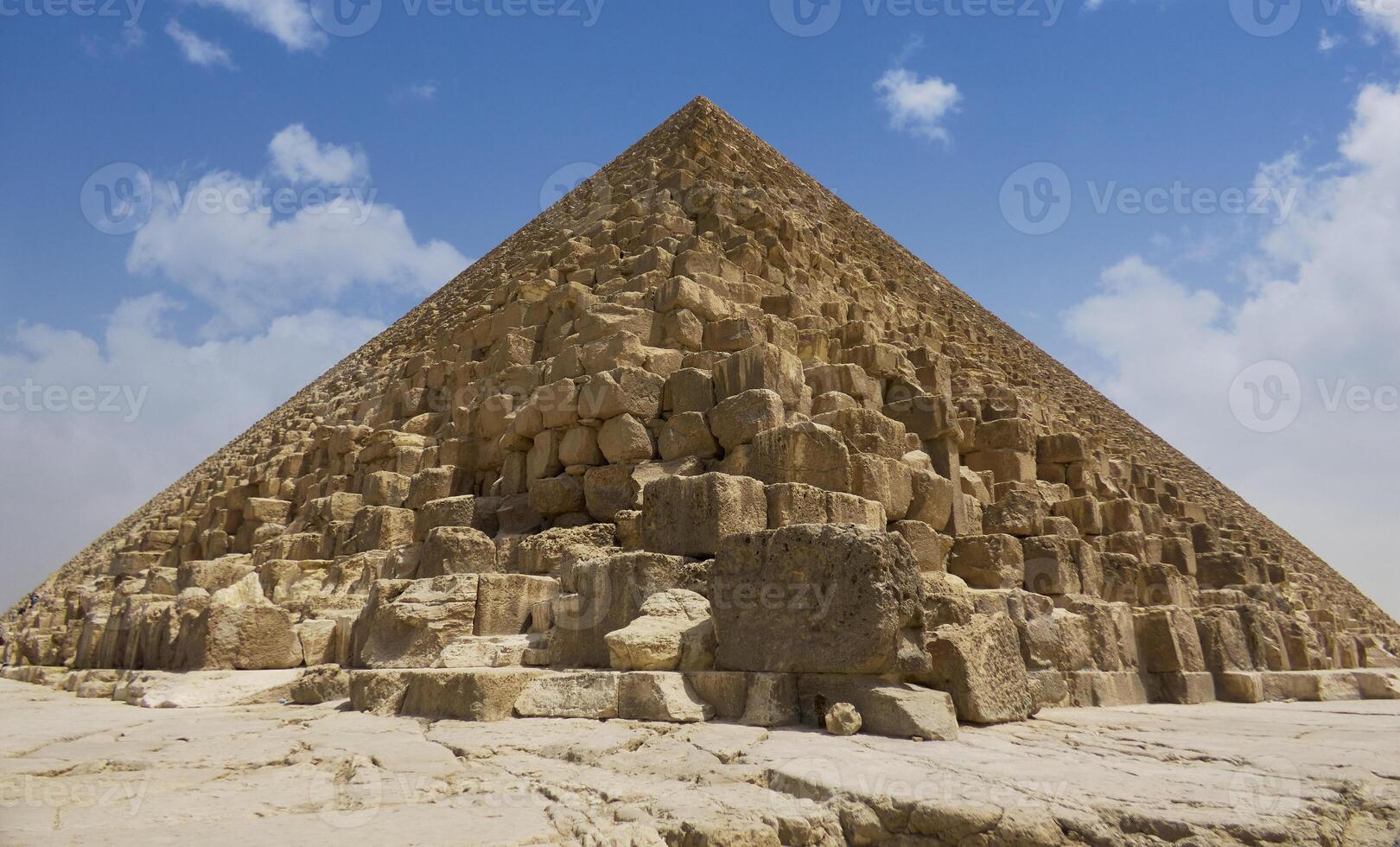 Egyptian pyramids in sand desert and clear sky photo