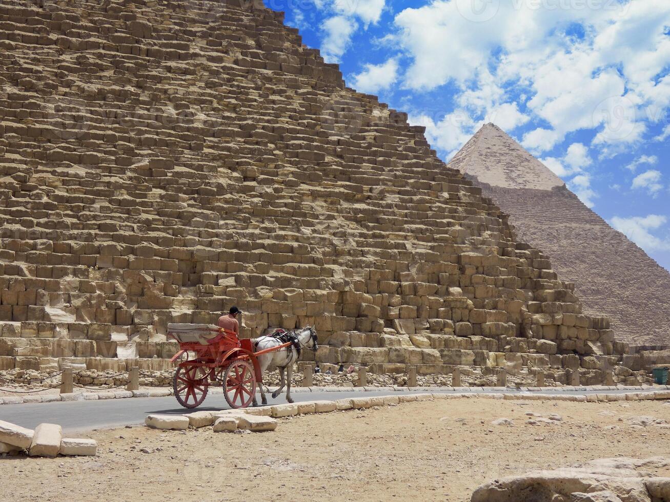 Egyptian pyramids in sand desert and clear sky photo