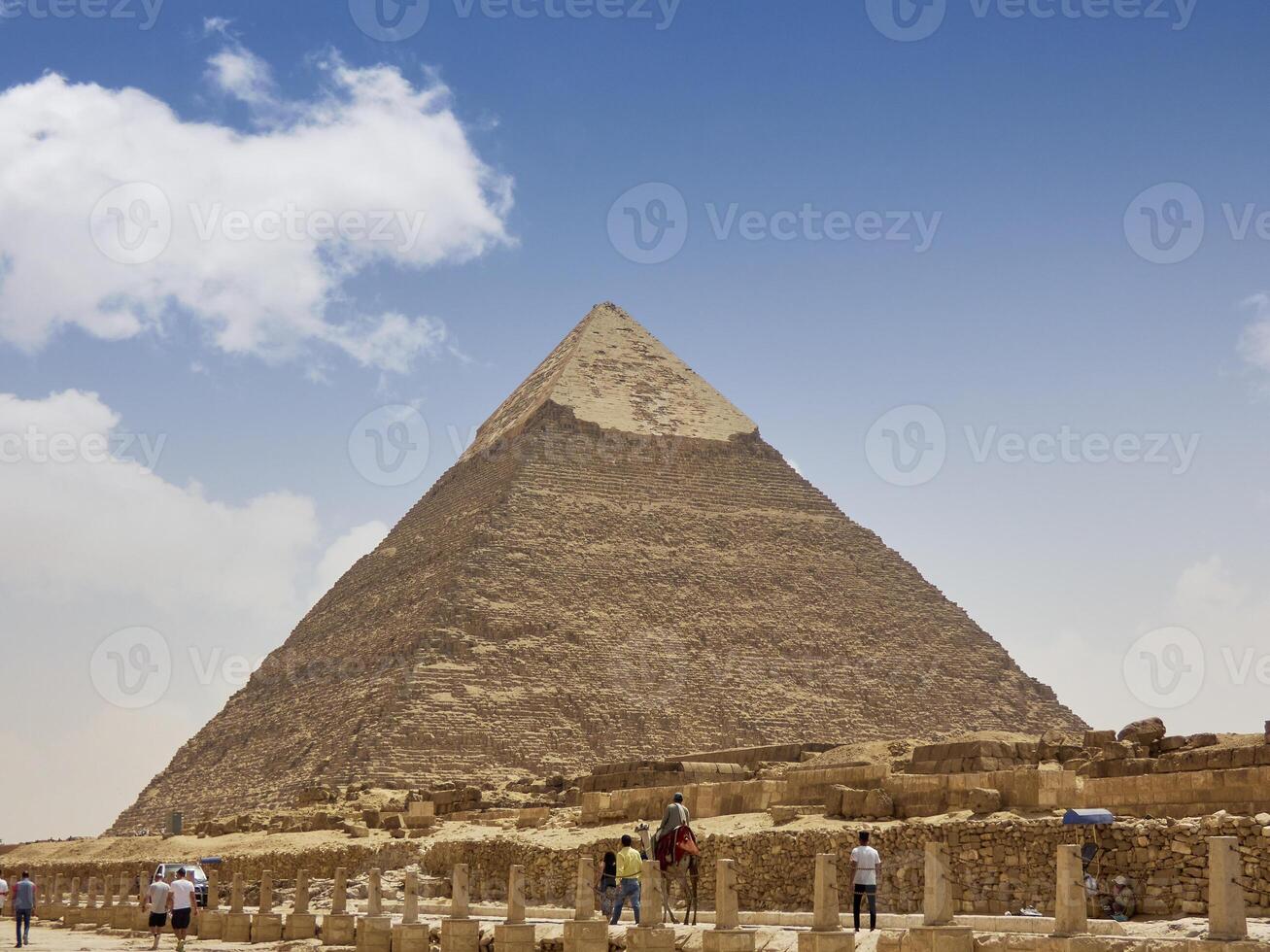 Egyptian pyramids in sand desert and clear sky photo