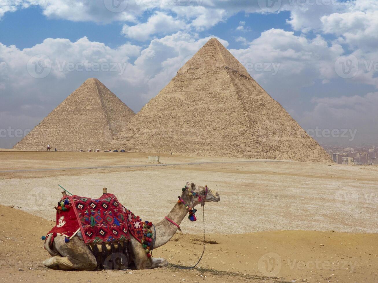 Egyptian pyramids in sand desert and clear sky photo