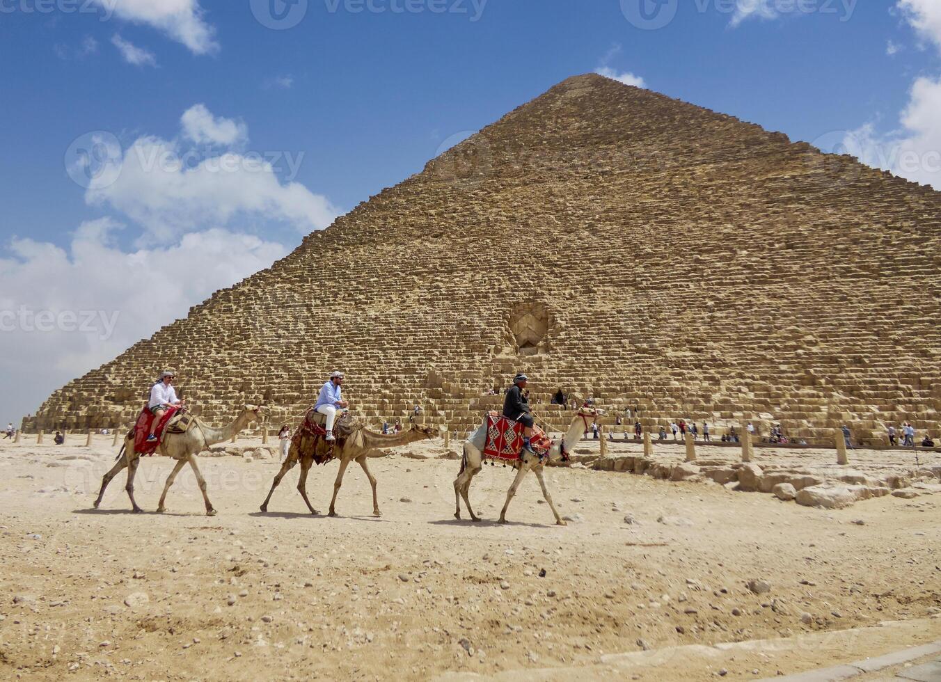 Egyptian pyramids in sand desert and clear sky photo