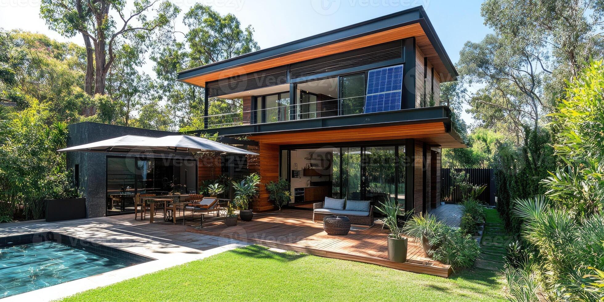 Modern sustainable home with solar panels, lush garden, and pool photo
