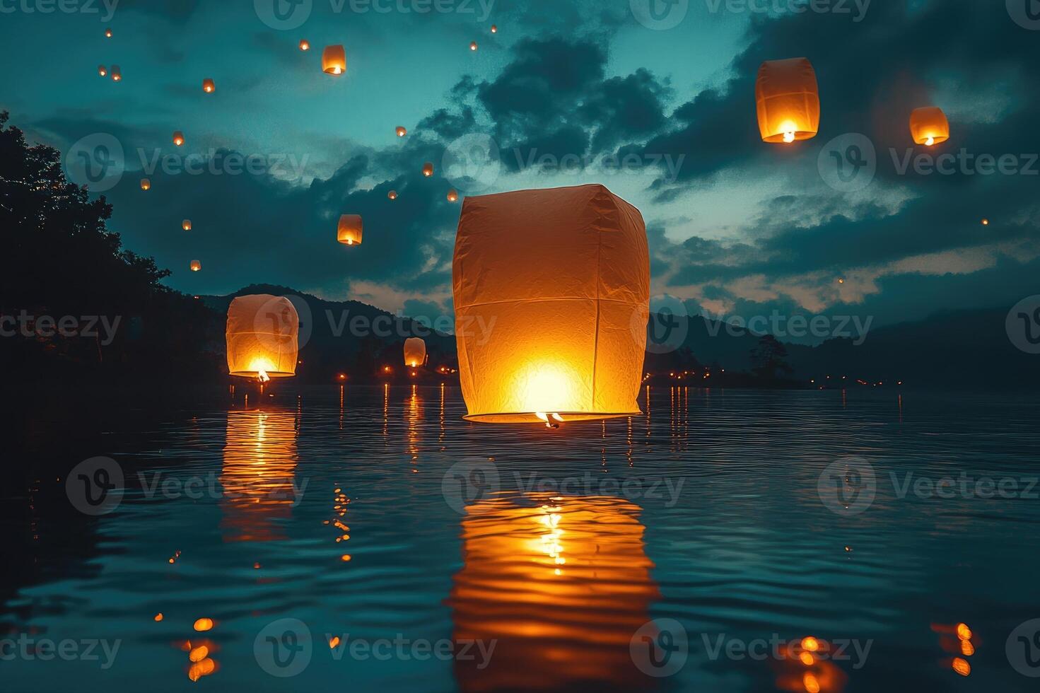 Sky lanterns floating on water at night reflecting on calm lake surface photo