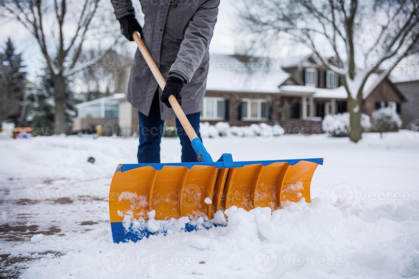 Homeowner removing snow from his driveway after a snowstorm photo
