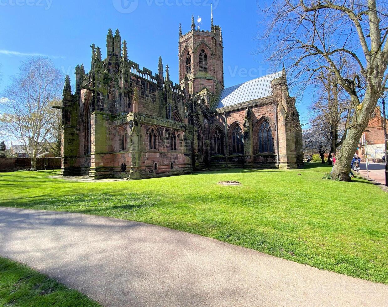 A large church with a green grassy area photo