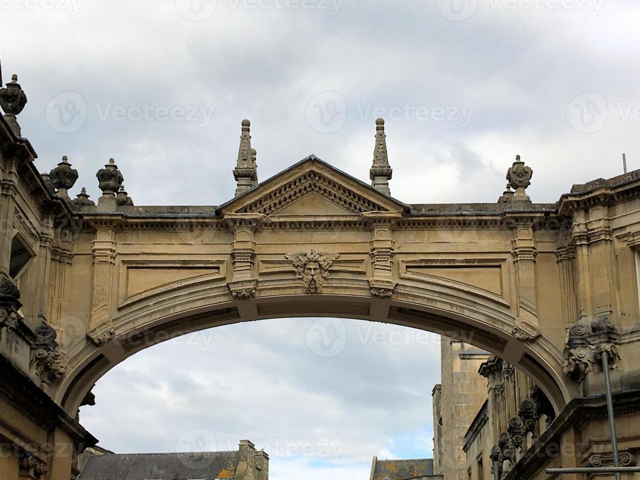 A stone archway with a clock tower on top photo