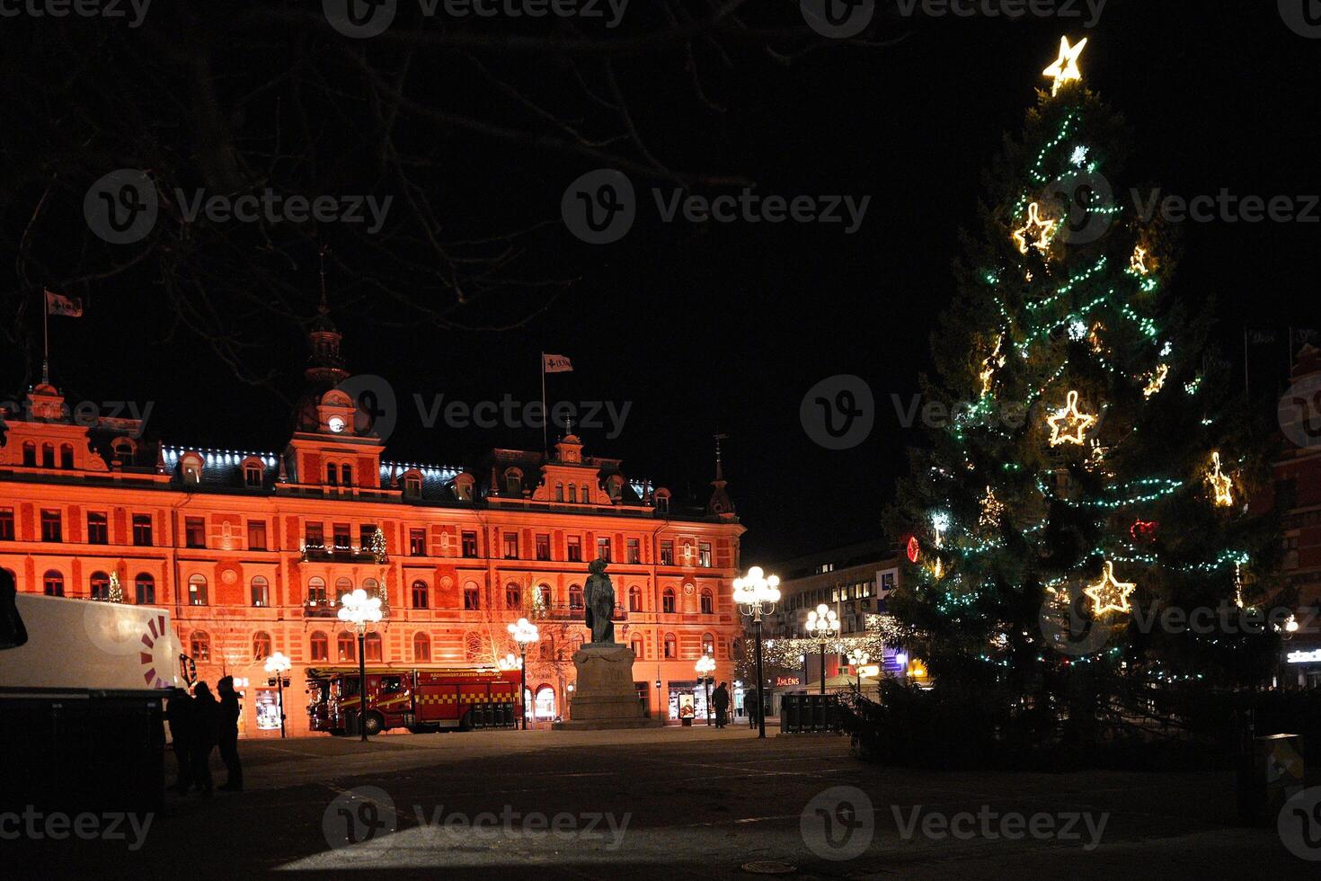 Festive Christmas Tree and Illuminated Building in Sundsvall, Sweden photo
