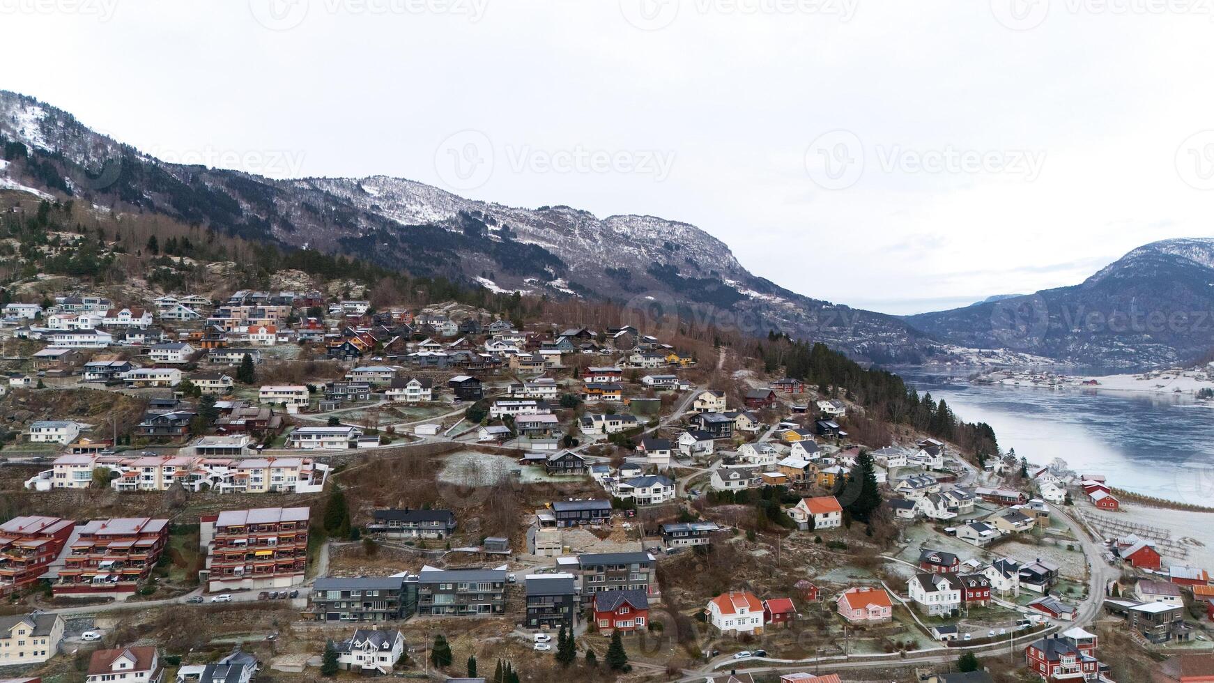 Hillside Homes in Norway Overlooking a Tranquil Fjord and Snowy Mountains photo