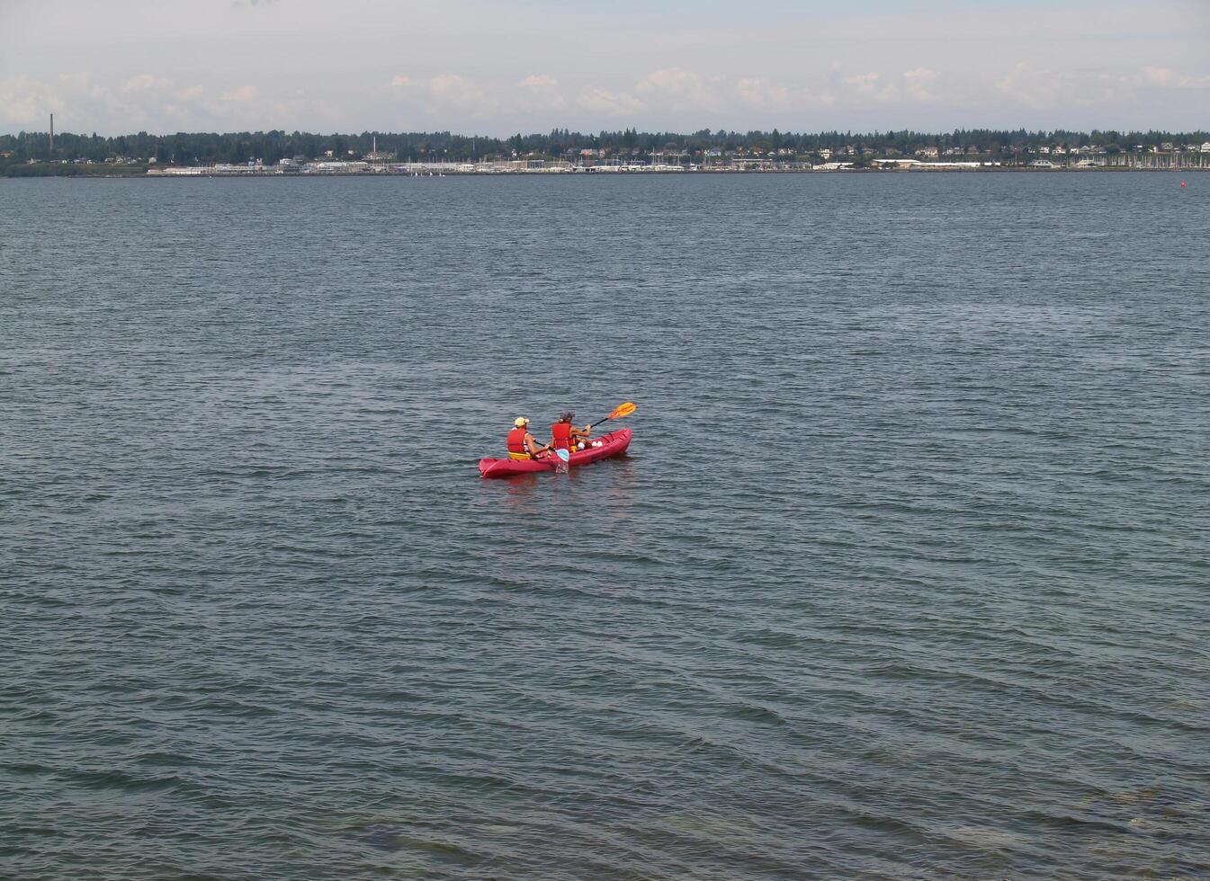 Monterey, CA, 2006 - Caucasian Man And Woman On Bay In Red Kayak photo