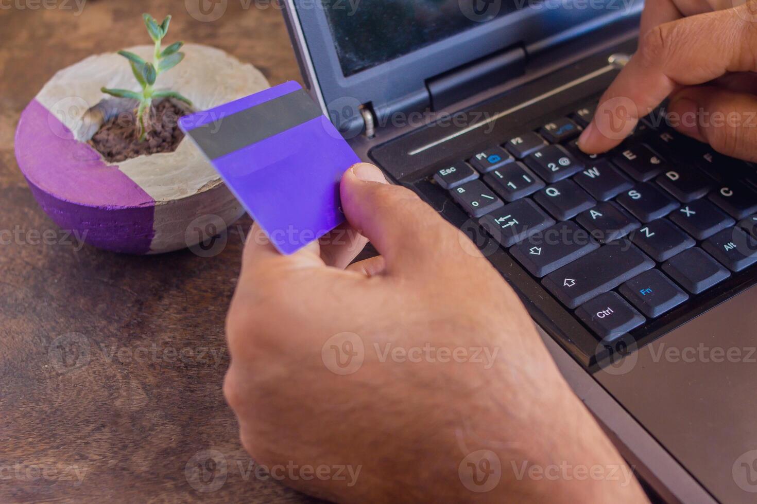 man making an online credit card payment from home - closeup photo