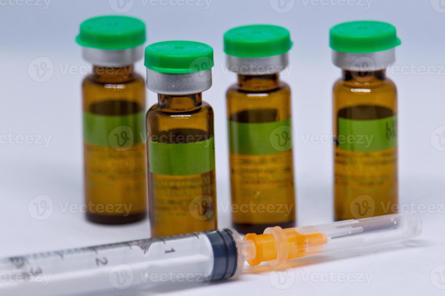 syringe and vials of injectable drugs - brown photo