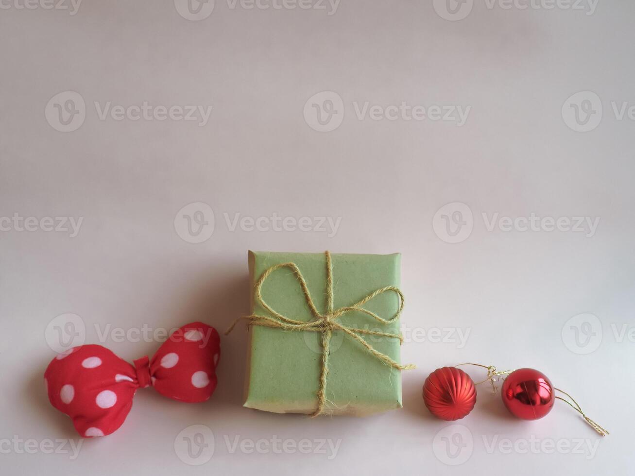 Christmas gifts and decorations on a minimalist pastel pink background. photo