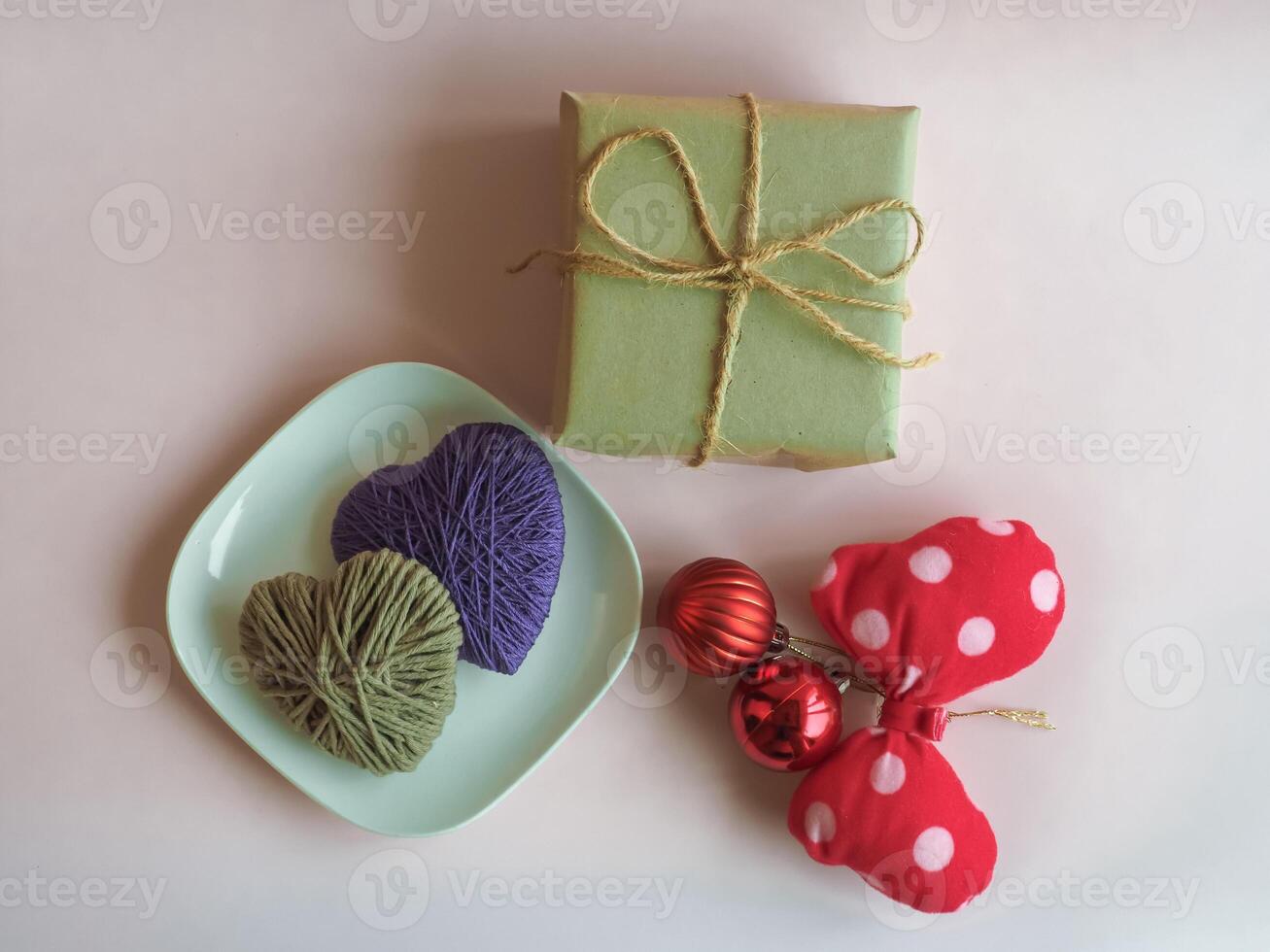 Christmas gifts and decorations on a minimalist pastel pink background. photo