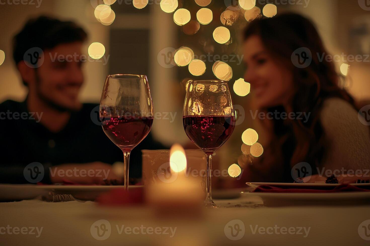Romantic dinner with red wine against soft evening lights, a couple enjoying the moment. Perfect for restaurant ads and festive events. photo
