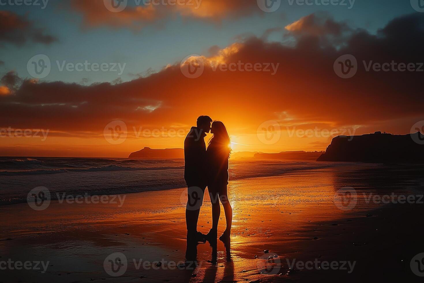 Perfect scene for Valentines Day with the silhouette of kissing on the beach with beautiful sunset in background. photo