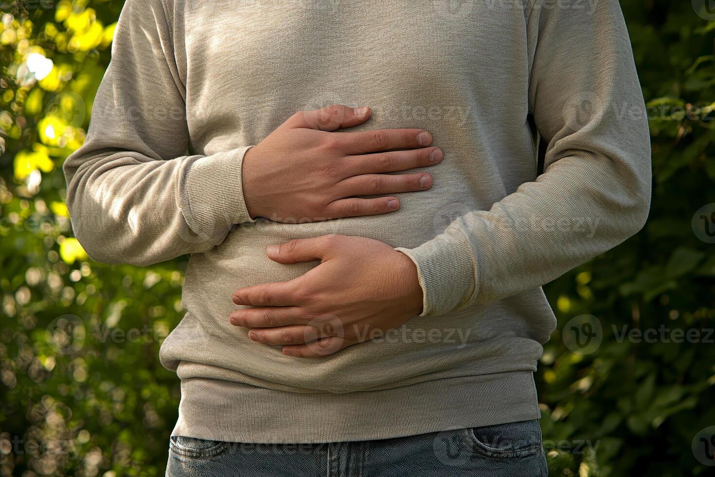 A person with a stomach ache. holding their stomach in pain. on white background. with white space photo