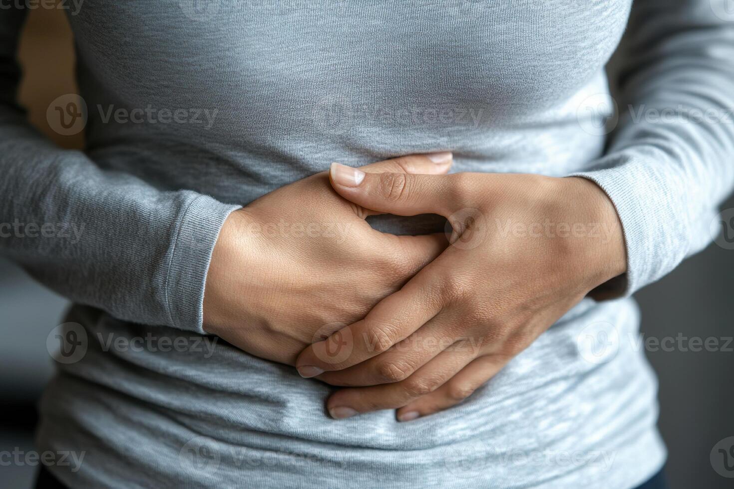 A person with a stomach ache. holding their stomach in pain. on white background. with white space photo