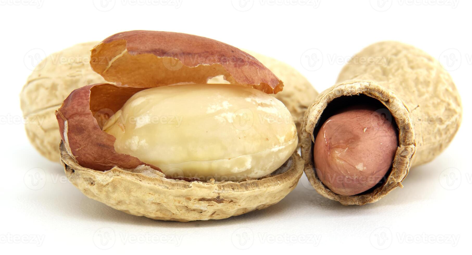 Close-Up of Whole and Shelled Peanuts on White Background photo
