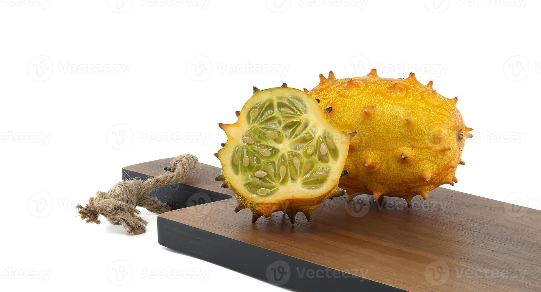Ripe horned cucumber, also known as spiked melon cut to reveal its unique interior isolated on white photo