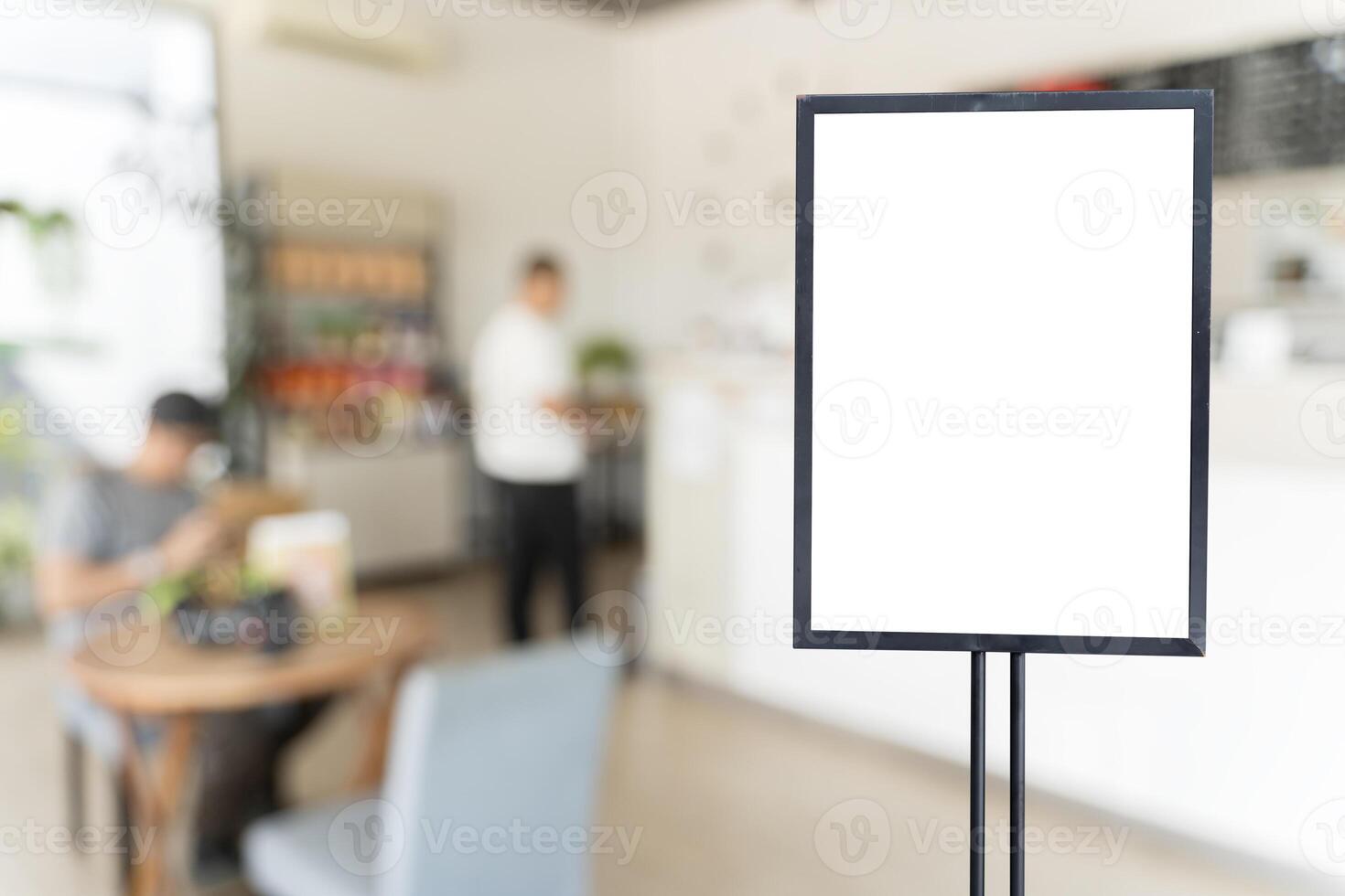 Shop sign on an easel mockup. White blank signboard stand near the entrance to the coffee shop photo