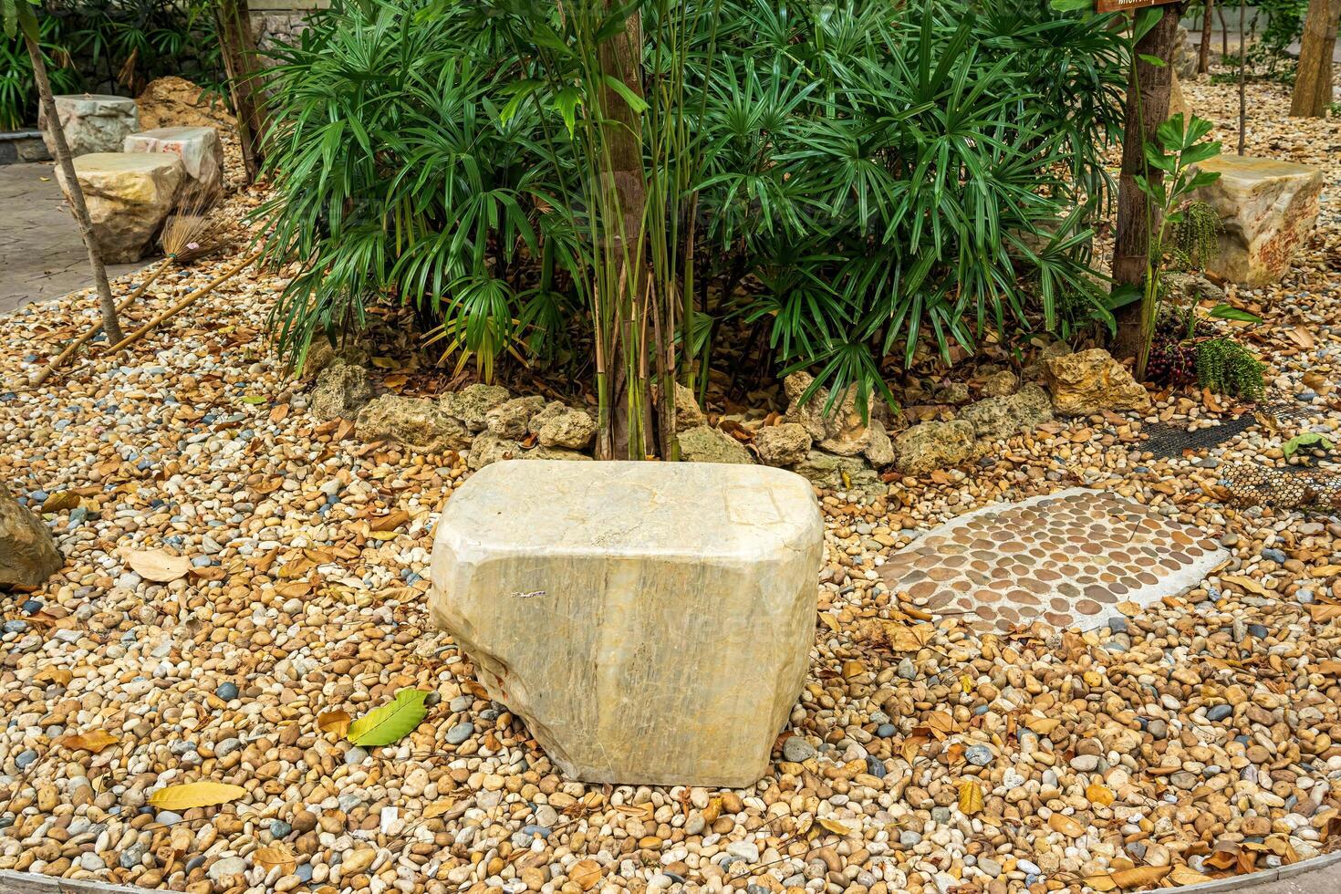 A large stone made into a chair to decorate the garden. photo