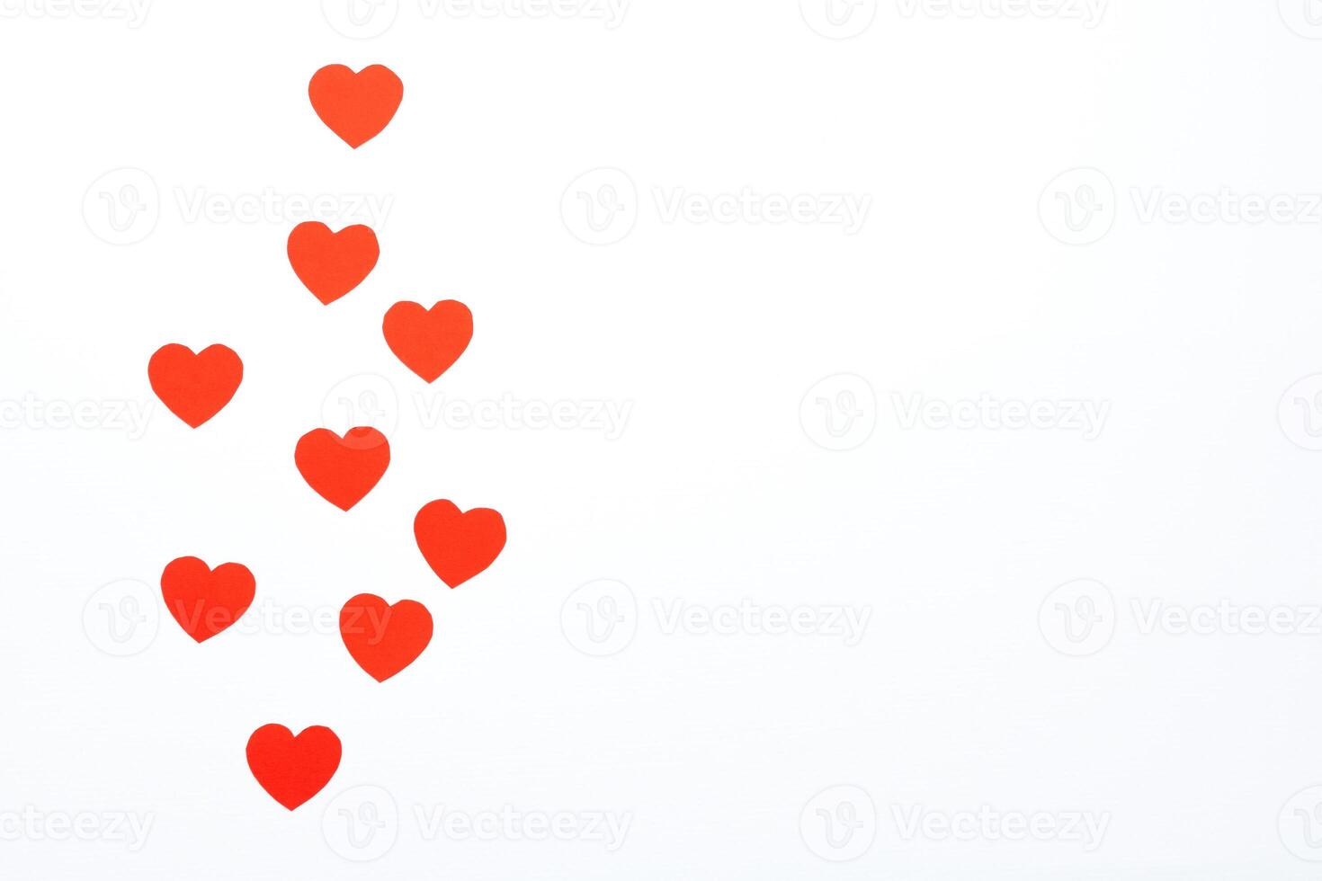 Red hearts made of paper on a white background. Top view. Valentine's Day. Symbol of love. photo