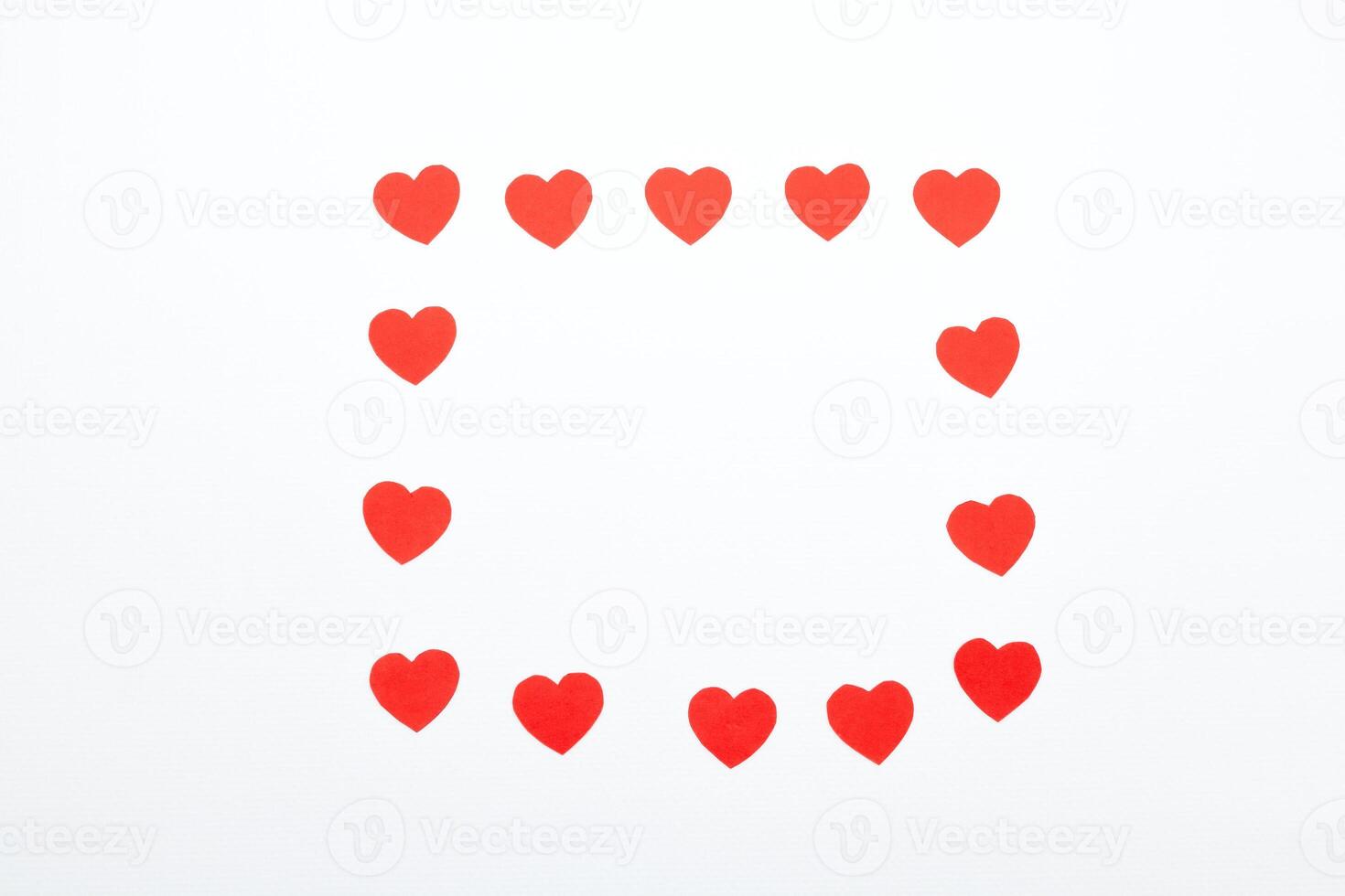 Red hearts made of paper on a white background. Top view. Valentine's Day. Symbol of love. photo