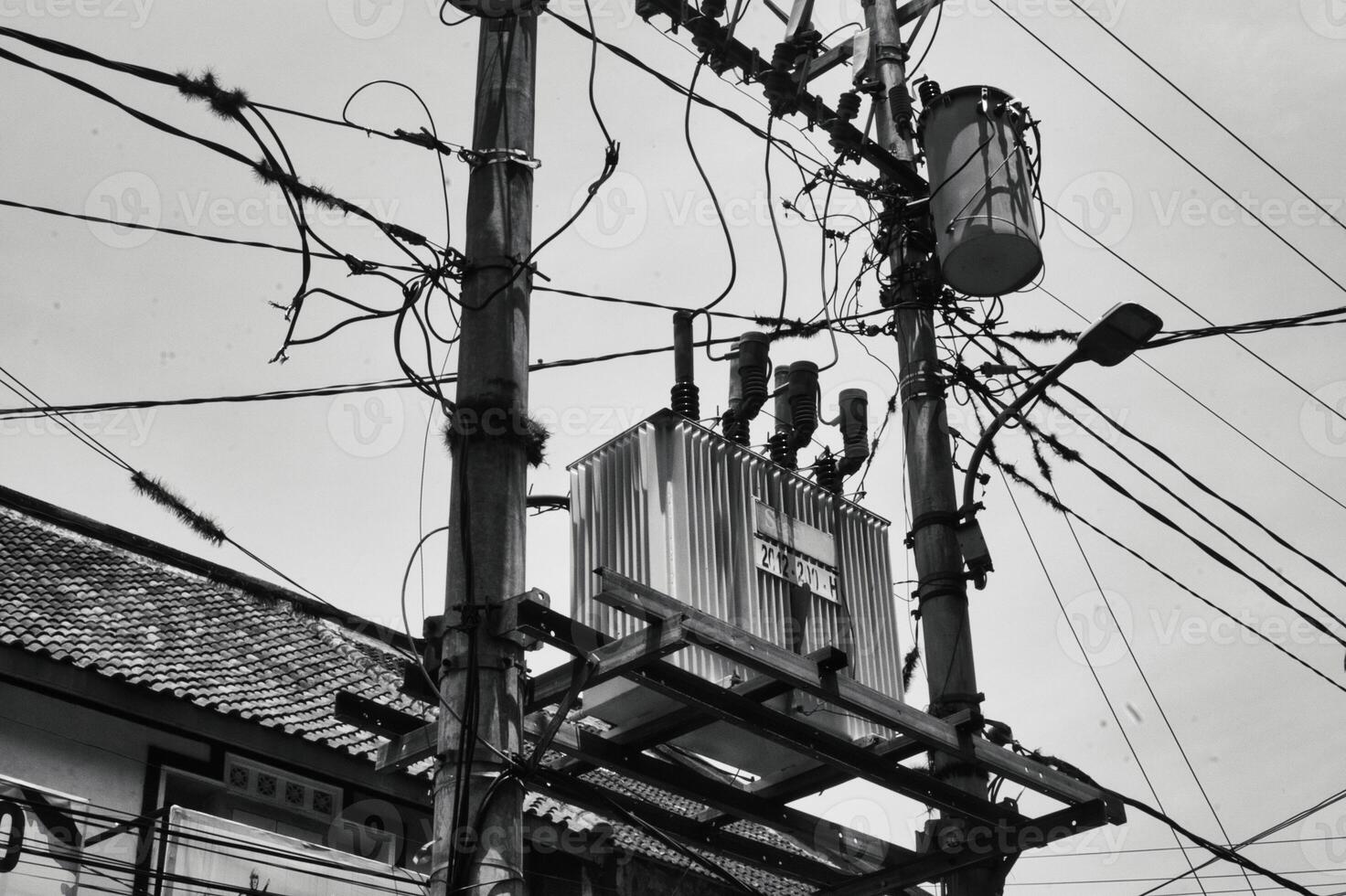 Urban Power Lines and Transformer in Black and White Cityscape photo