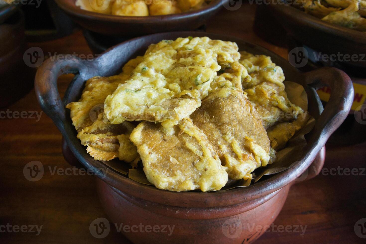 Traditional Indonesian Tempeh Fritters Served in Rustic Clay Pot photo
