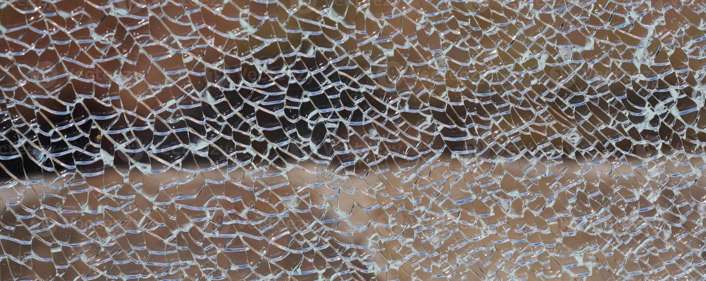 Cracked clear glass full frame. Close up photo