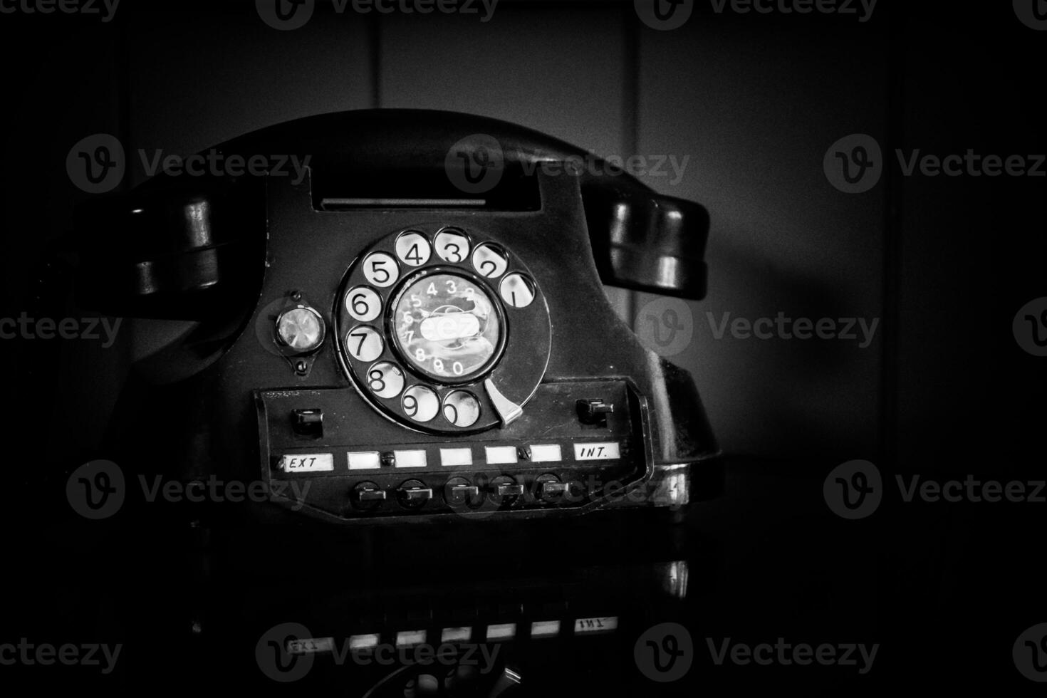Old, retro and vintage landline rotary telephone in noir style photo