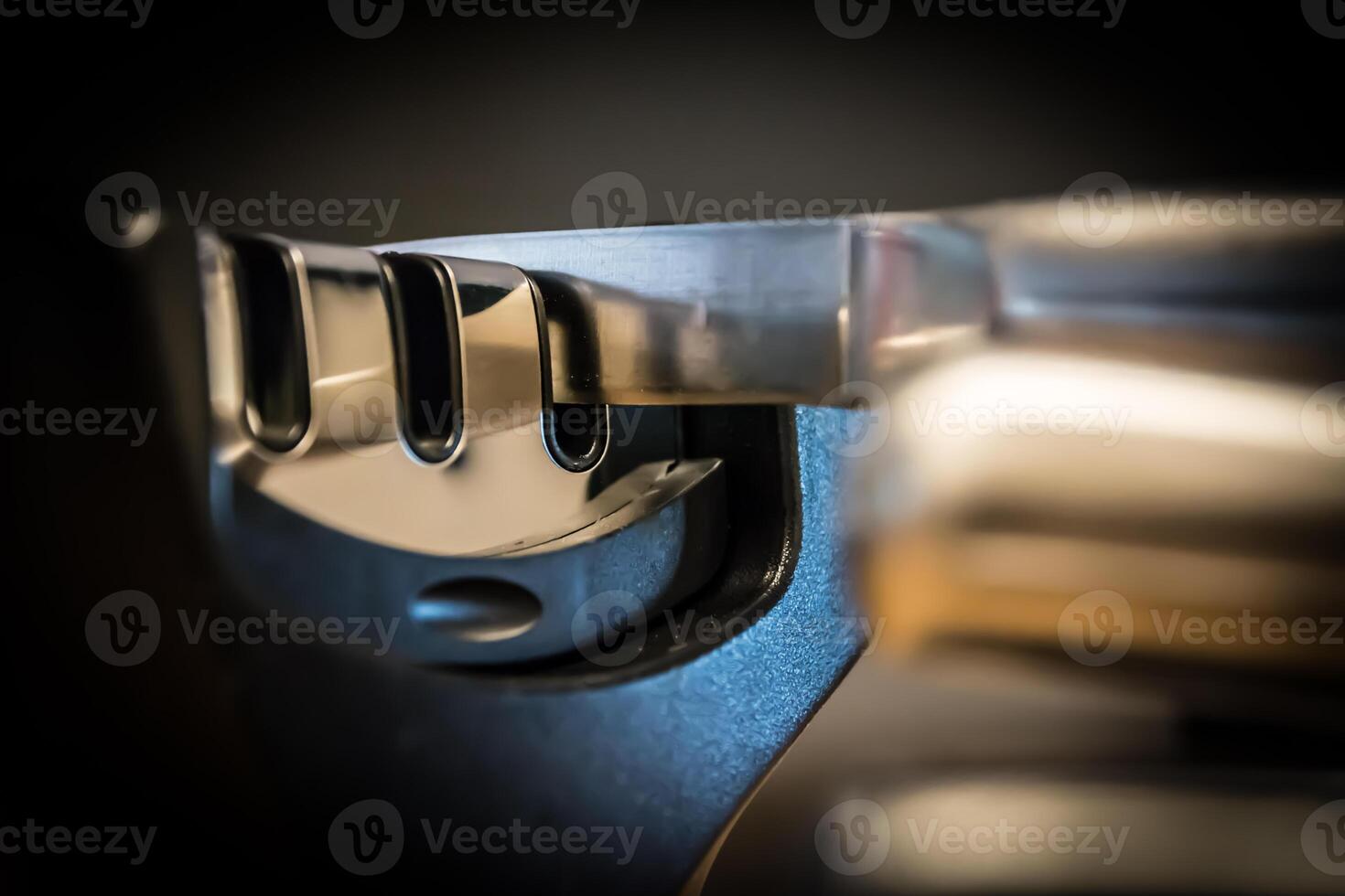Close-up and detail of a knife in a knife sharpener kitchen tool. photo