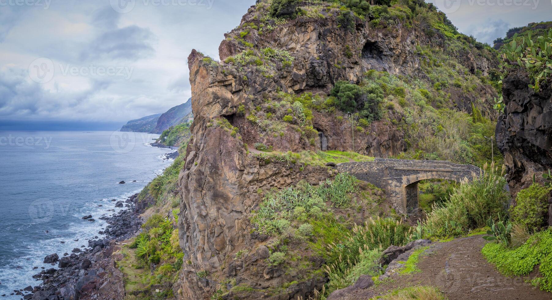 View on the old stone bridge and surrounding landscape near Ponta do Sol on ER101 road on Madeira, Portugal photo