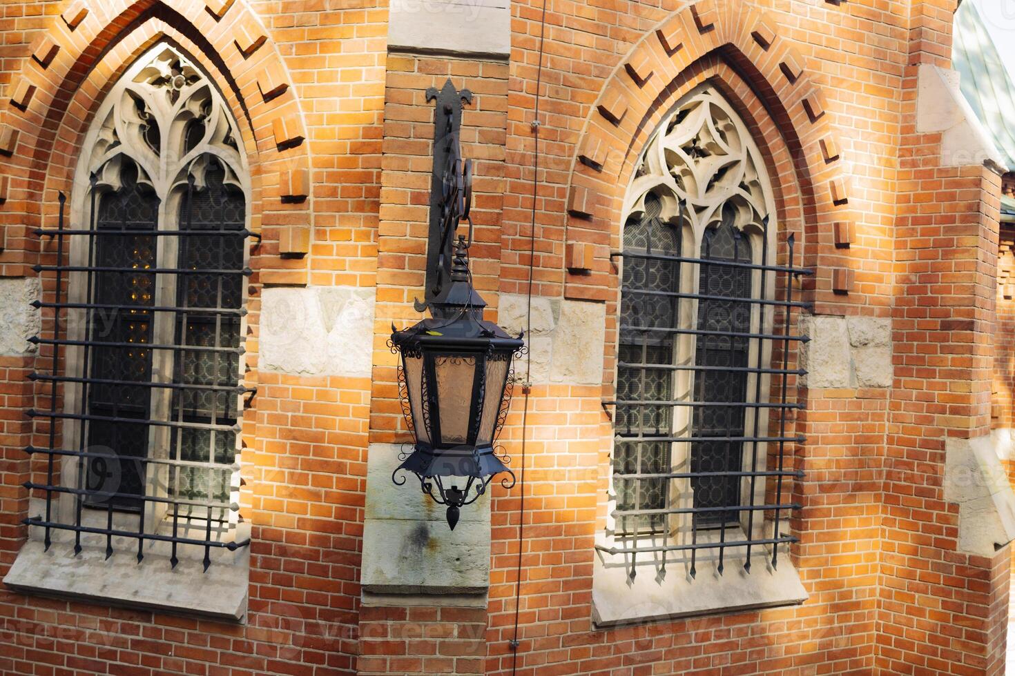 Vintage lantern and traditional old houses in Krakow, Poland. Vintage gasoline oil lantern lamp with a soft glow light photo