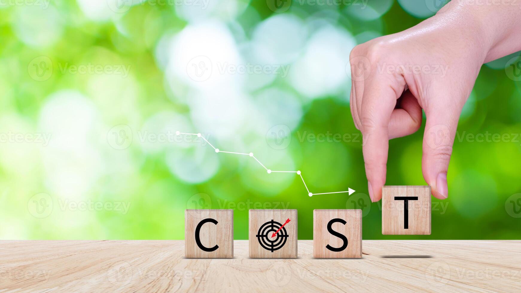 Cost reduction concept on wooden cube, Expenses and saving money, Business strategy and project management, cost reduction, efficient business and budget cutting. photo